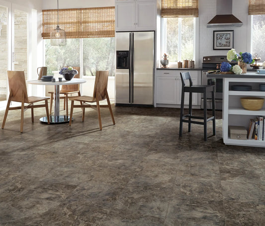 Modern kitchen with tiled floor, wooden chairs, and stainless steel appliances.