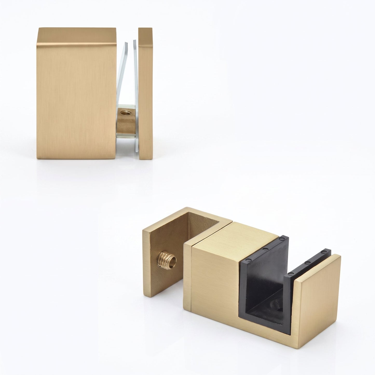 Two modern wall-mounted hardware pieces in a brushed brass/gold finish, shown on a clean white studio background. One piece is positioned upper left and the other lower right, both displaying a square block design with a side screw and a dark inner insert.