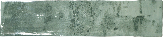 A rectangular ceramic subway tile with a green glaze.