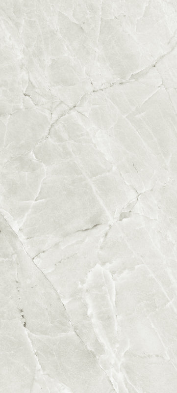 A close-up of a light gray to off-white marble or quartzite surface with natural veining and a polished texture.