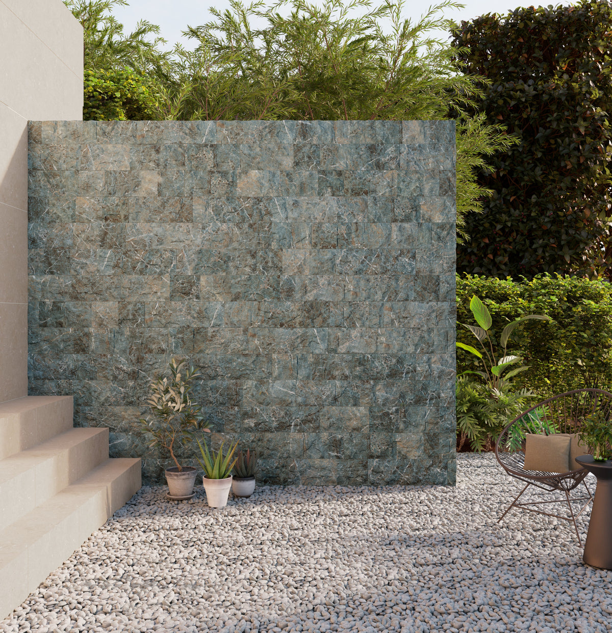 Stone wall in a garden setting with plants and a chair