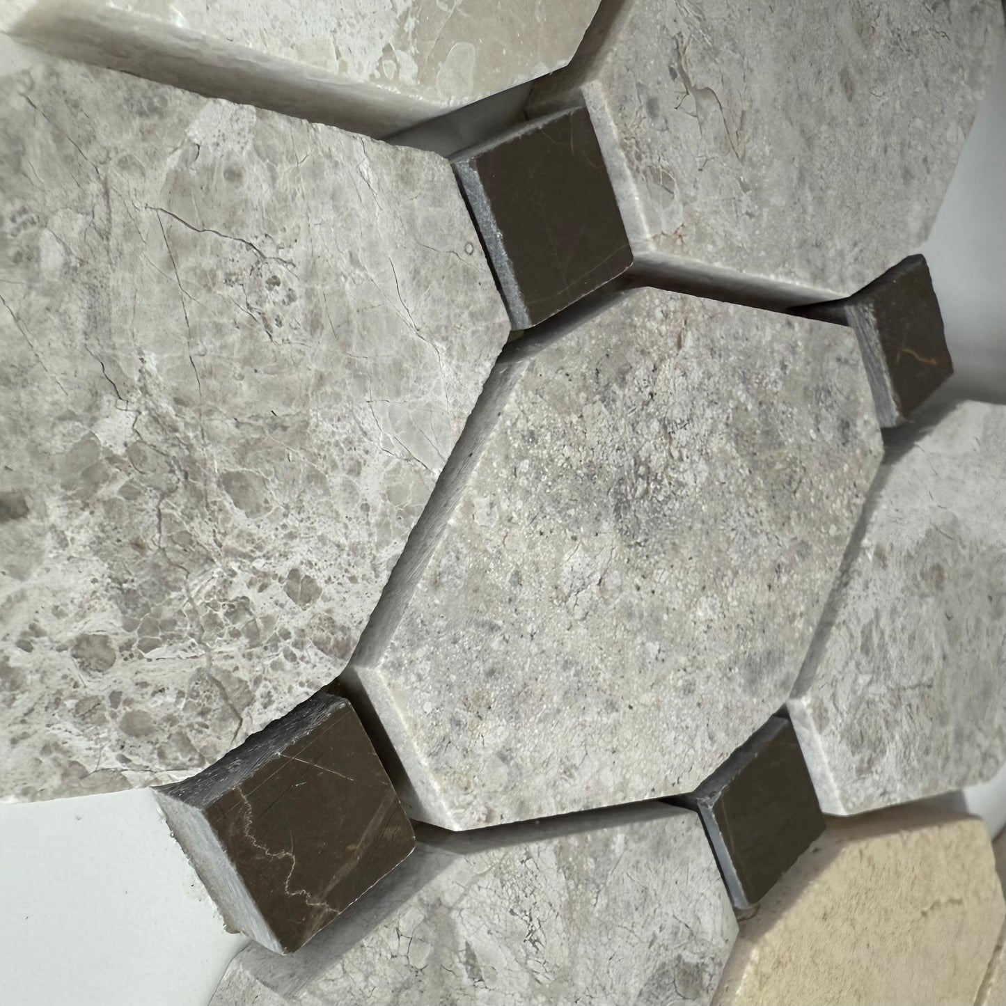 Hexagonal stone tiles with a marble-like texture on a floor.