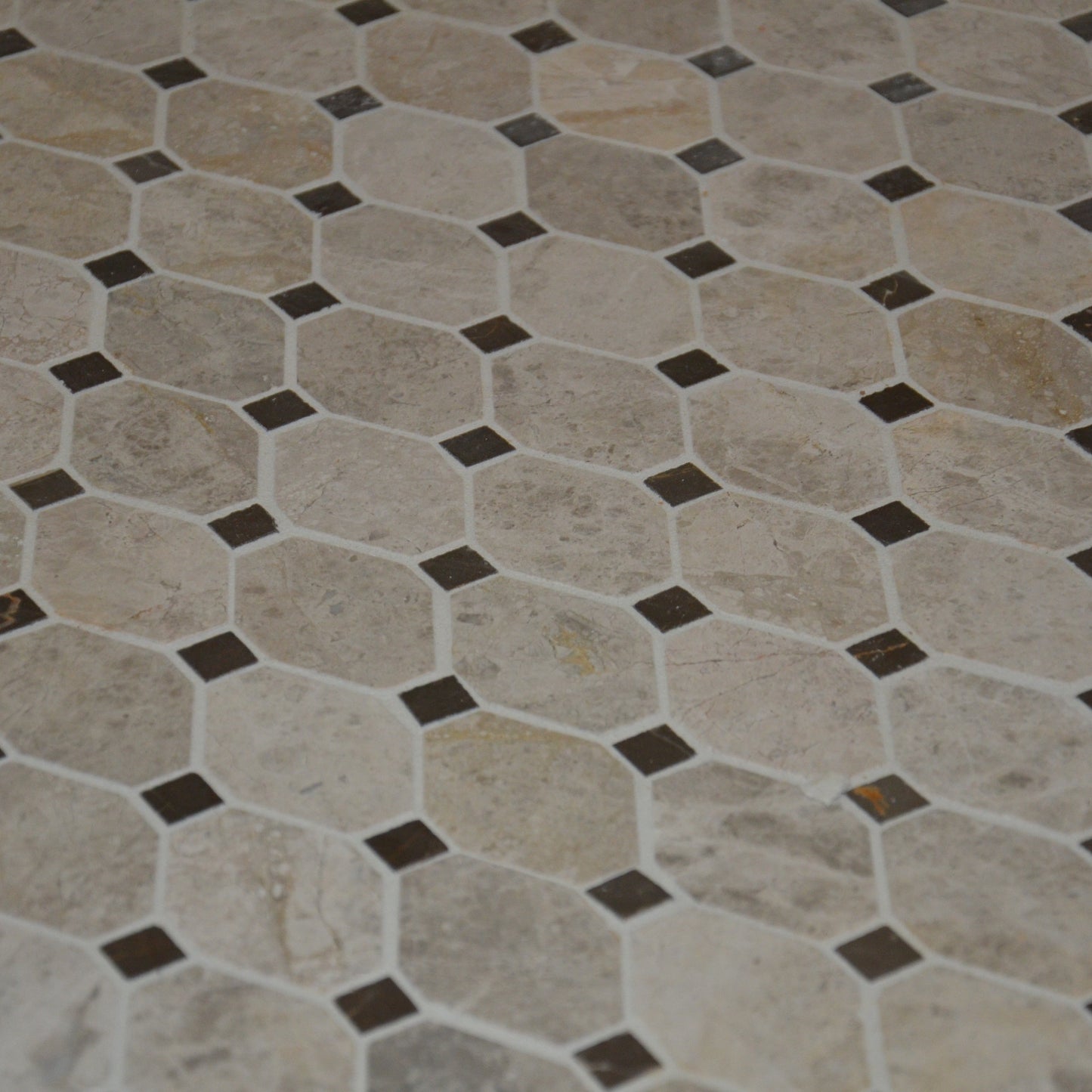 Hexagonal tile pattern with brown accents on a floor