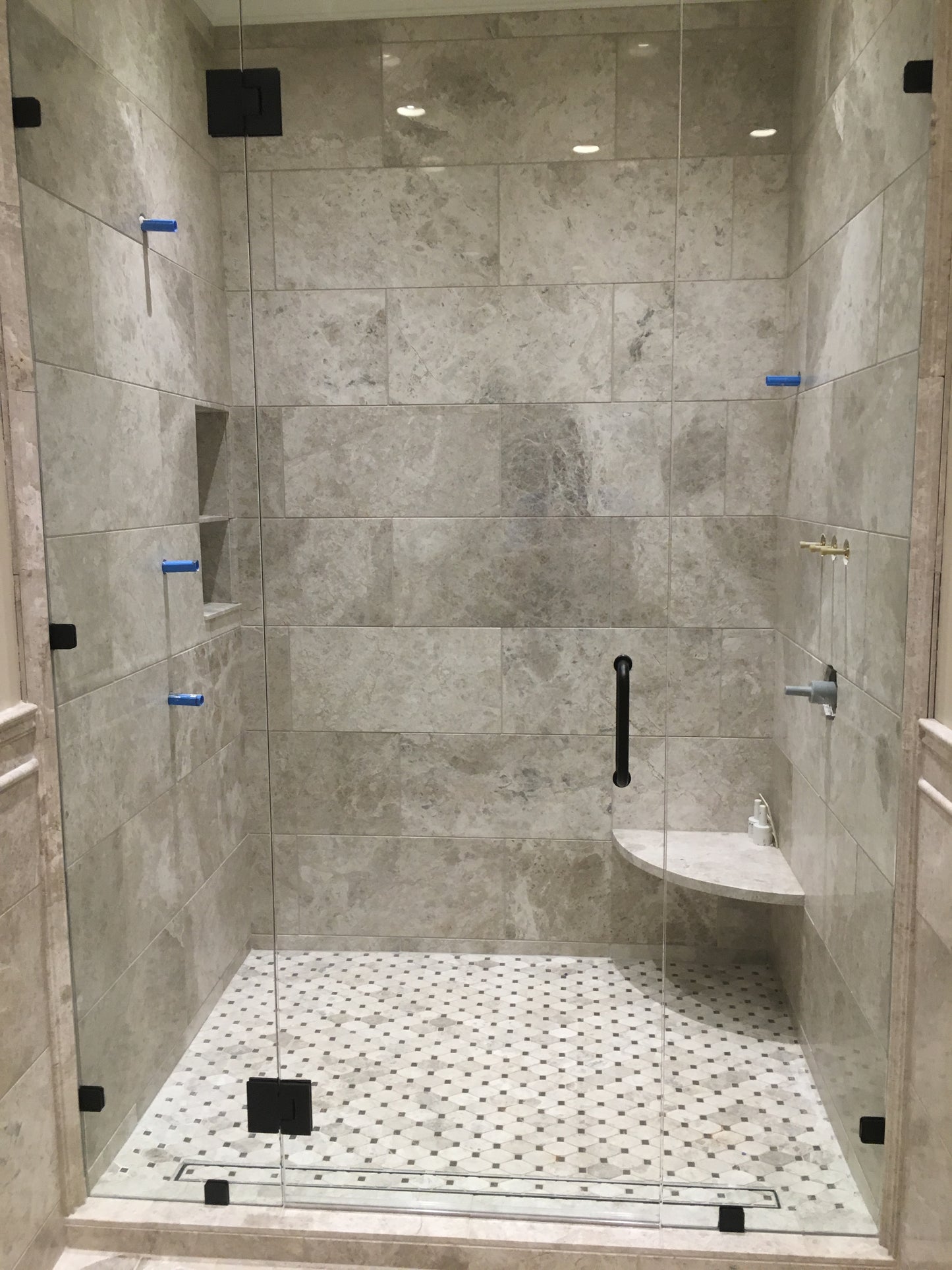 Modern shower room with tiled walls and glass partition
