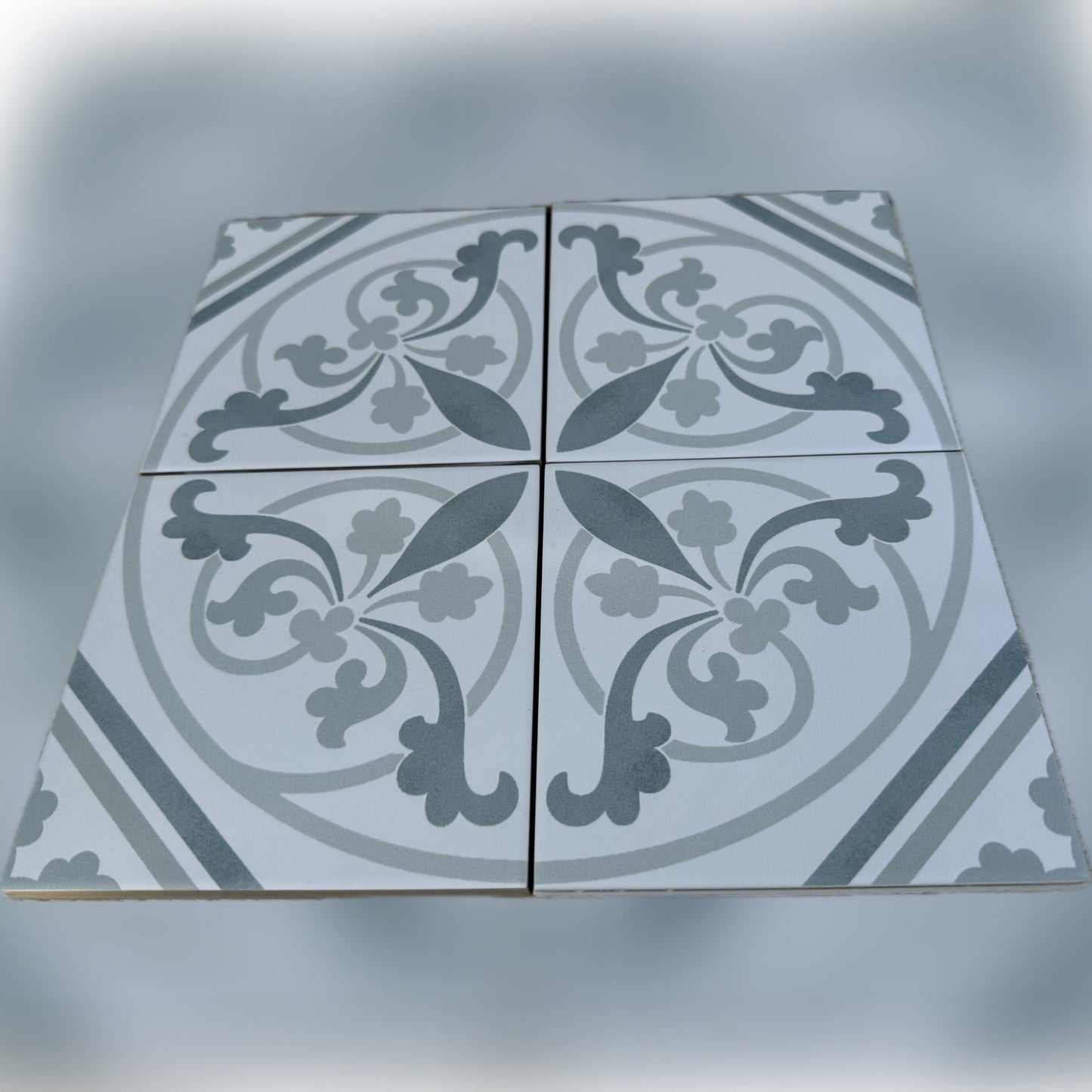 Decorative tile with floral pattern on a gray background