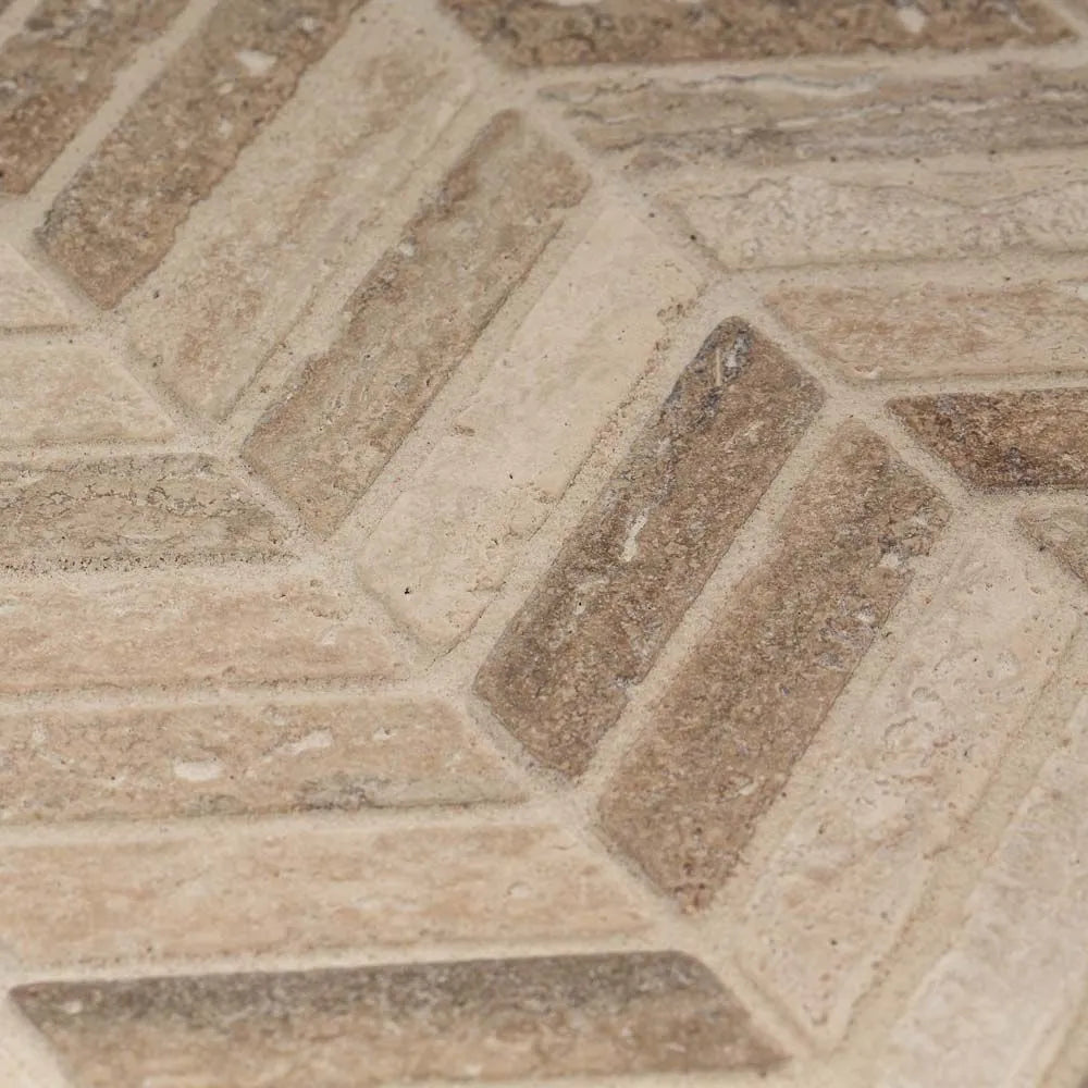 Close-up of stone tiles with a herringbone pattern