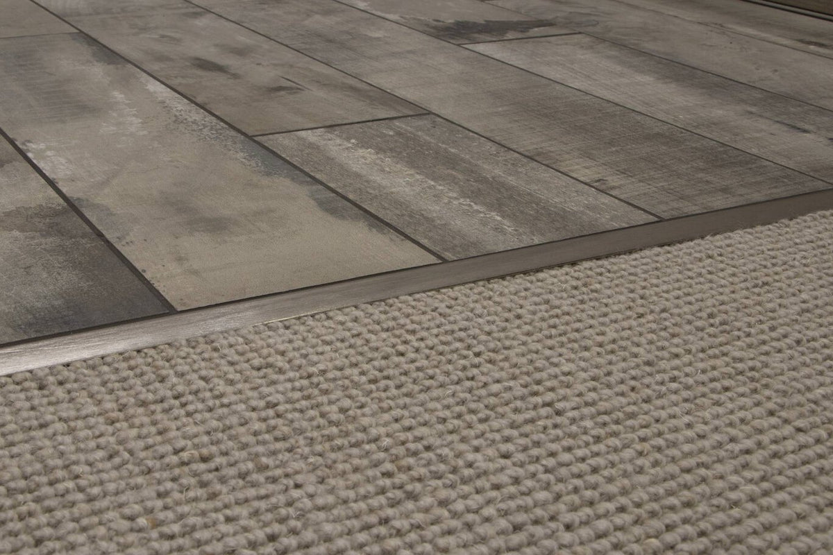 Close-up of a floor transitioning to a textured rug.