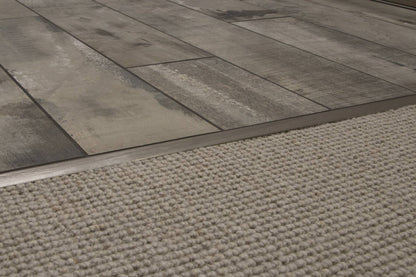 Close-up of a floor transitioning to a textured rug.