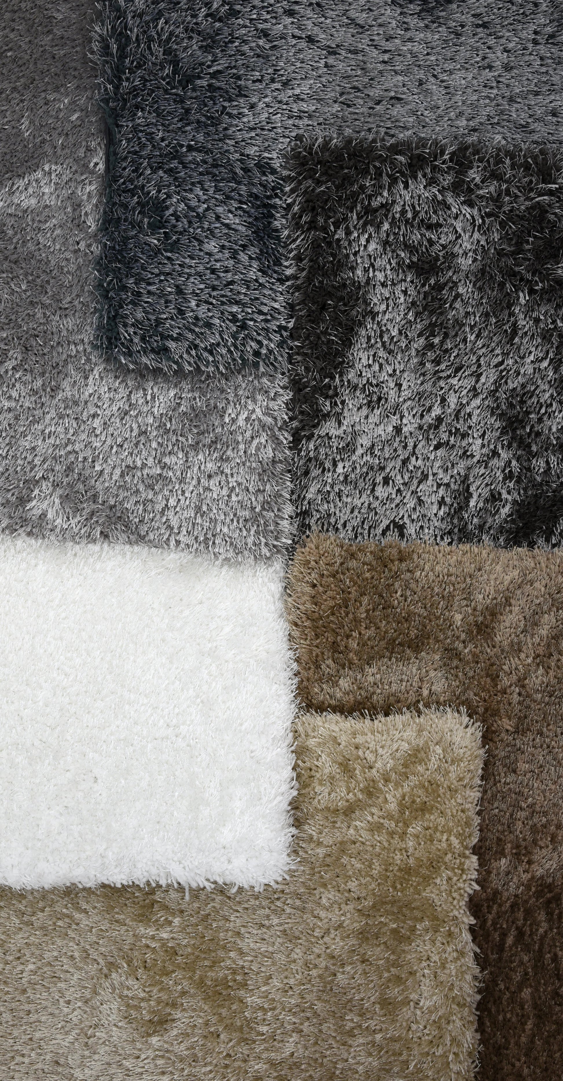 A close-up of several plush shaggy fabric or carpet swatches arranged in a grid, showing colors including white, taupe, brown, charcoal, and dark gray.