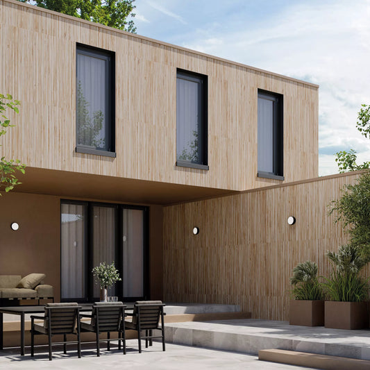 Modern house exterior with wooden facade, outdoor seating area, and potted plants.