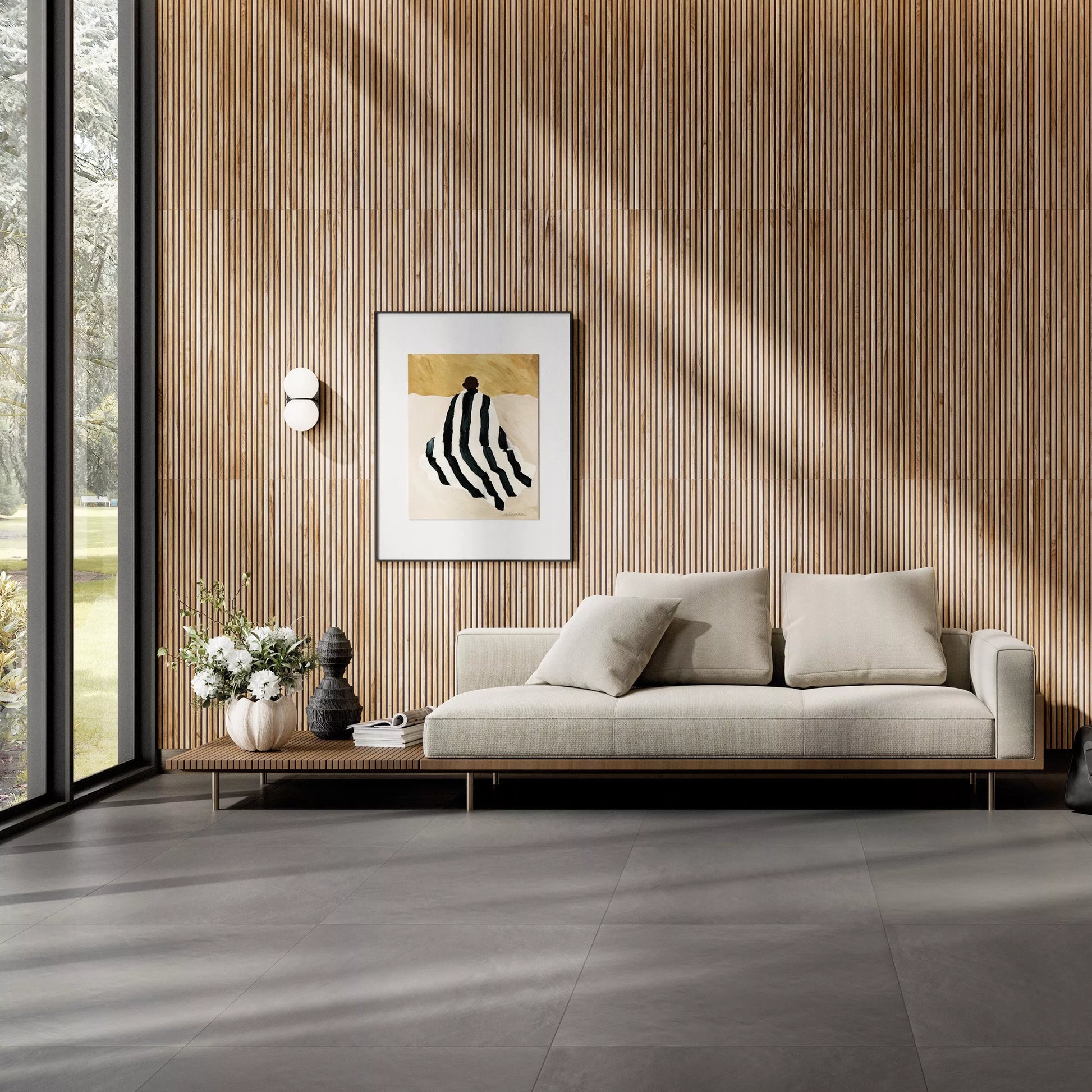 Modern living room with a light gray sofa, decorative pillows, and a wall art piece.