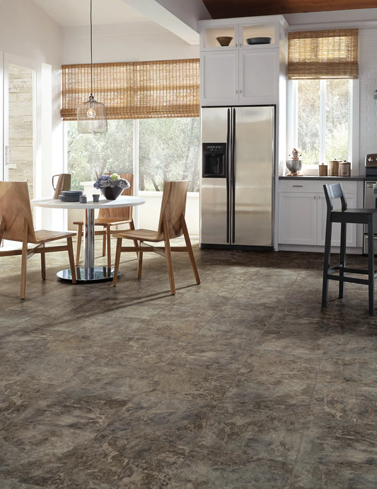 Brown and gray stone-look porcelain or ceramic floor tiles installed in a modern kitchen and dining room setting.