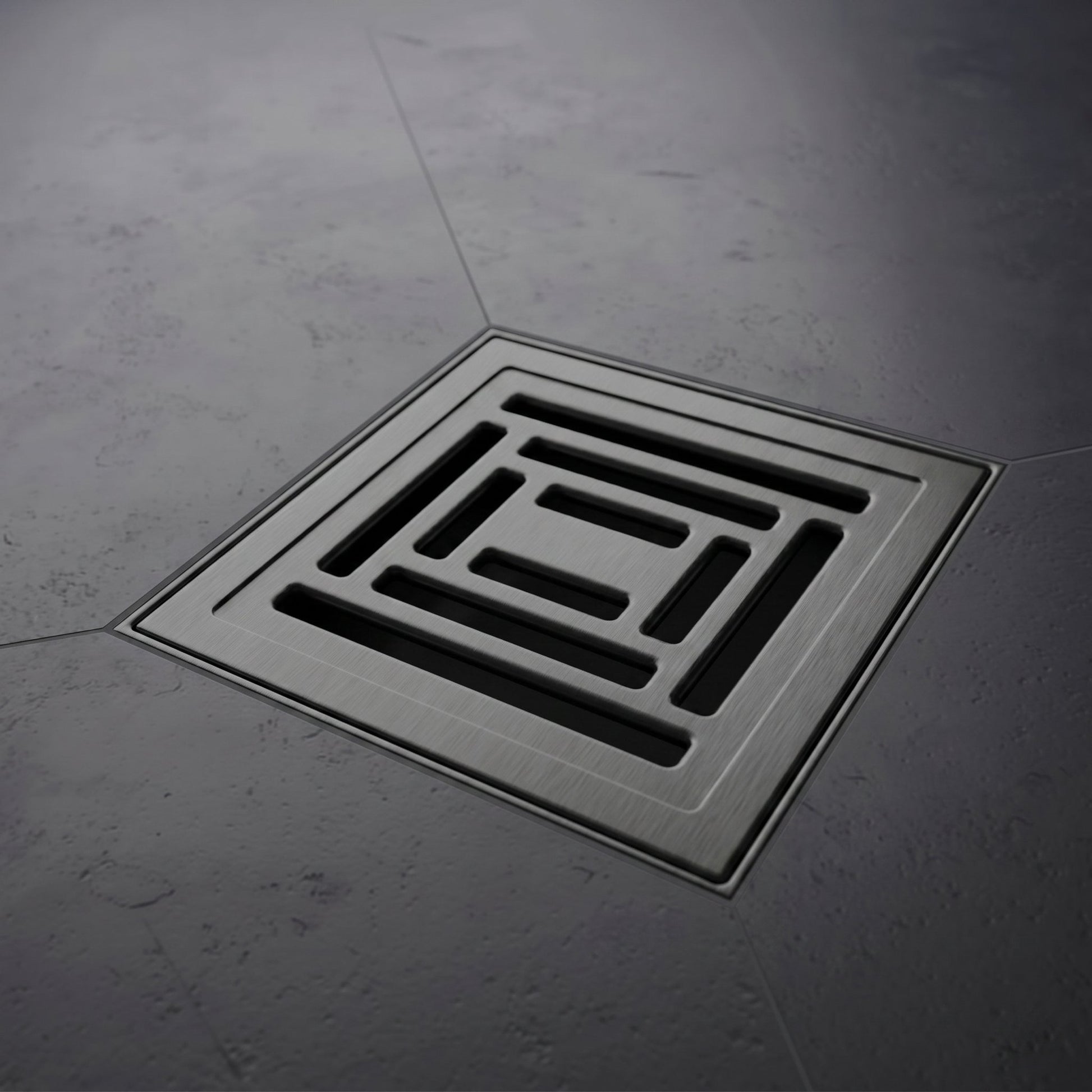Square floor drain cover on a gray concrete floor
