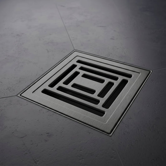 Square floor drain cover on a gray concrete floor
