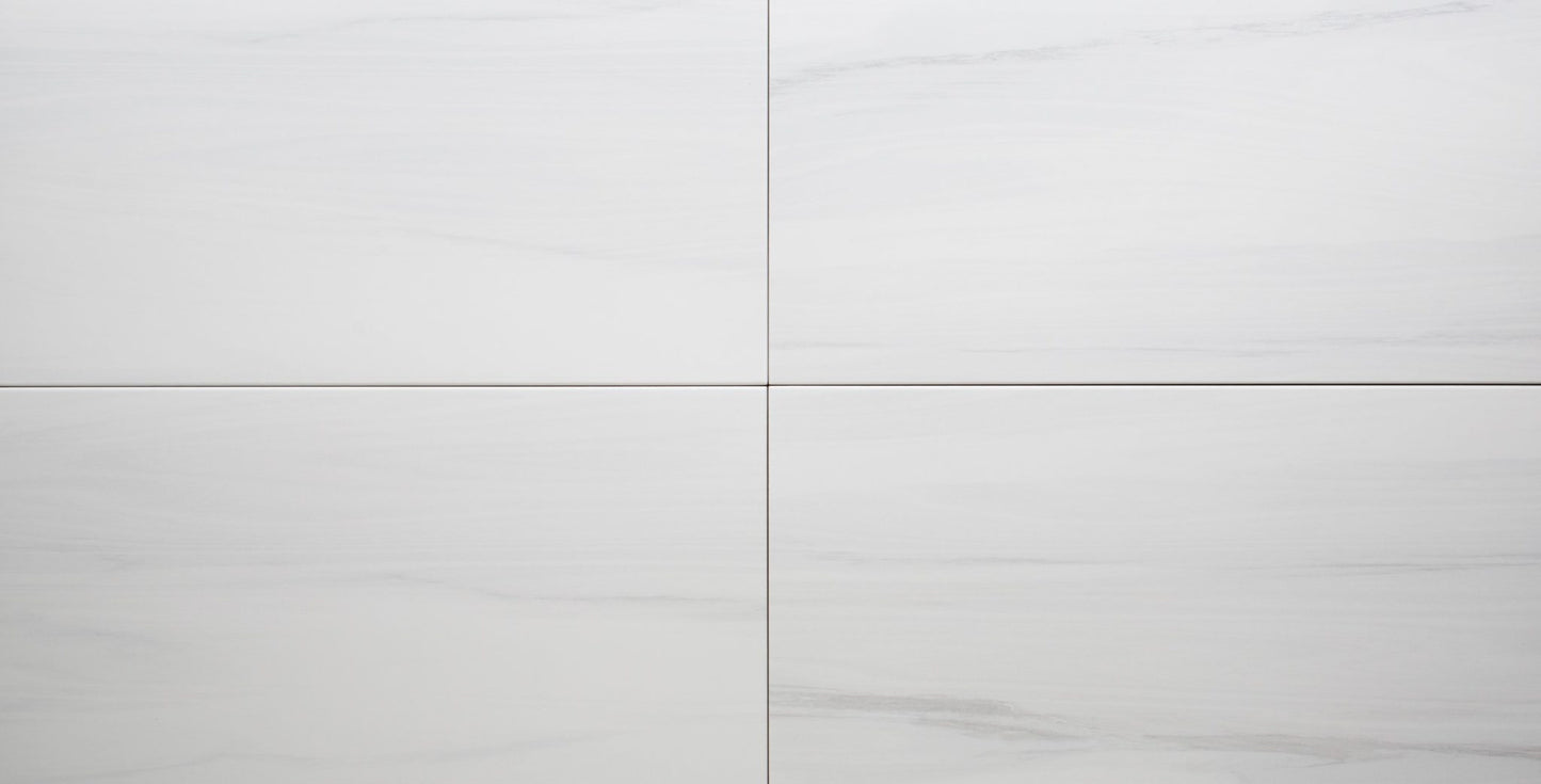 Close-up of a white ceramic tile with a subtle pattern