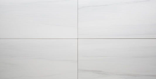 Close-up of a white ceramic tile with a subtle pattern