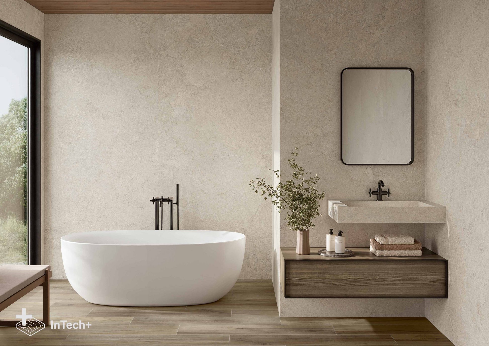 A modern bathroom interior featuring a white freestanding bathtub, a floating vanity with a white sink and mirror, wood flooring, and textured beige walls. A small window on the left shows greenery outside.