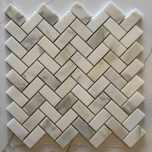 Marble mosaic tile with herringbone pattern on a light background
