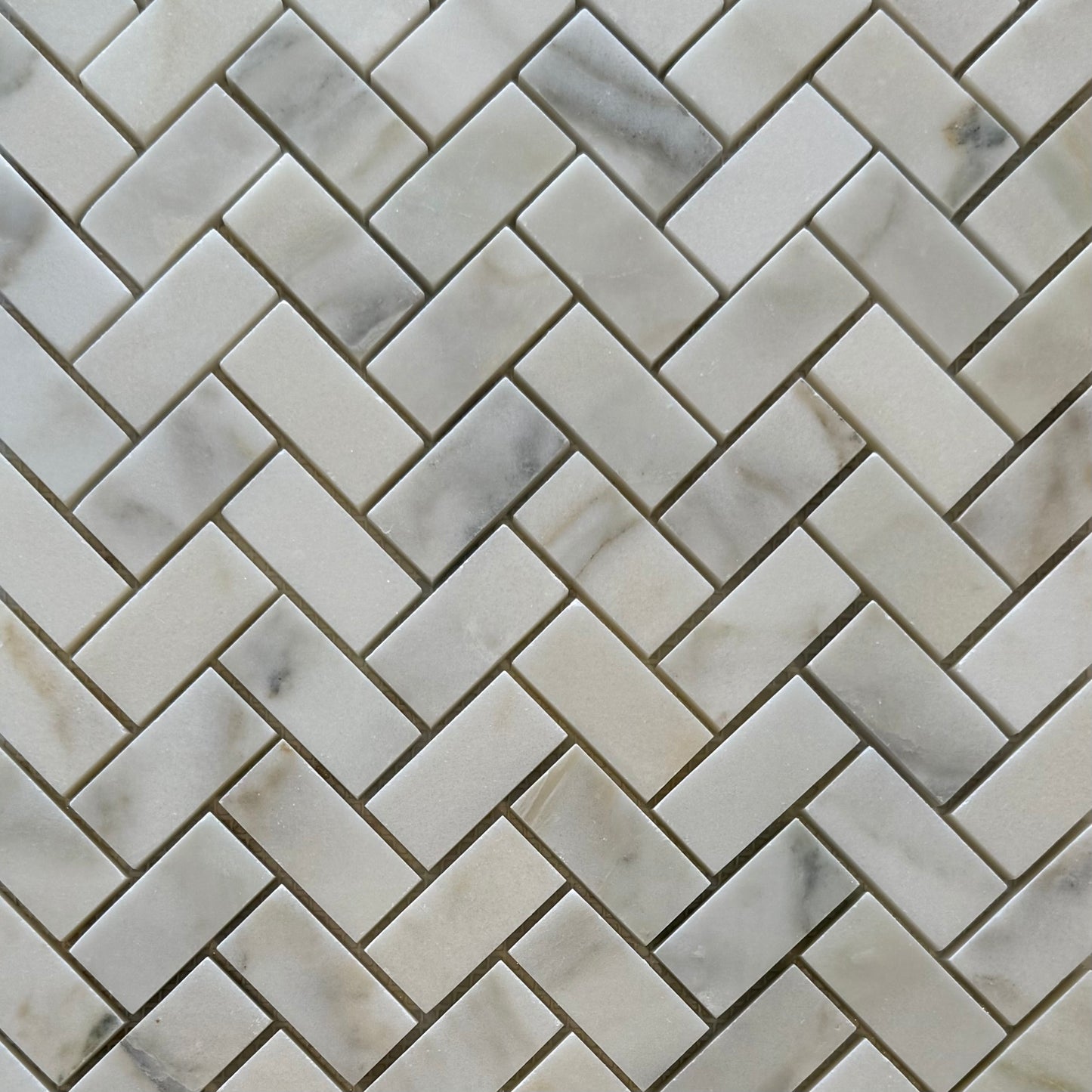 Marble tiles arranged in a herringbone pattern