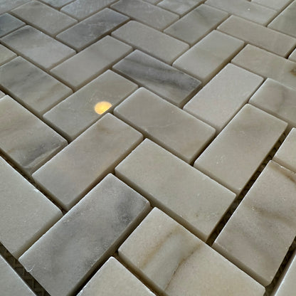Close-up of stone tiles arranged in a herringbone pattern