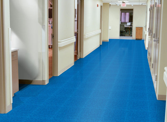 Corridor with blue vinyl composition tile and office doors along the way