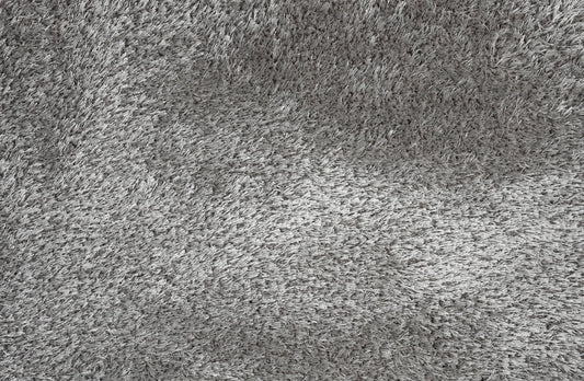 A close-up texture shot of a gray shaggy or high-pile carpet, showing the dense fibers and soft, fluffy surface.