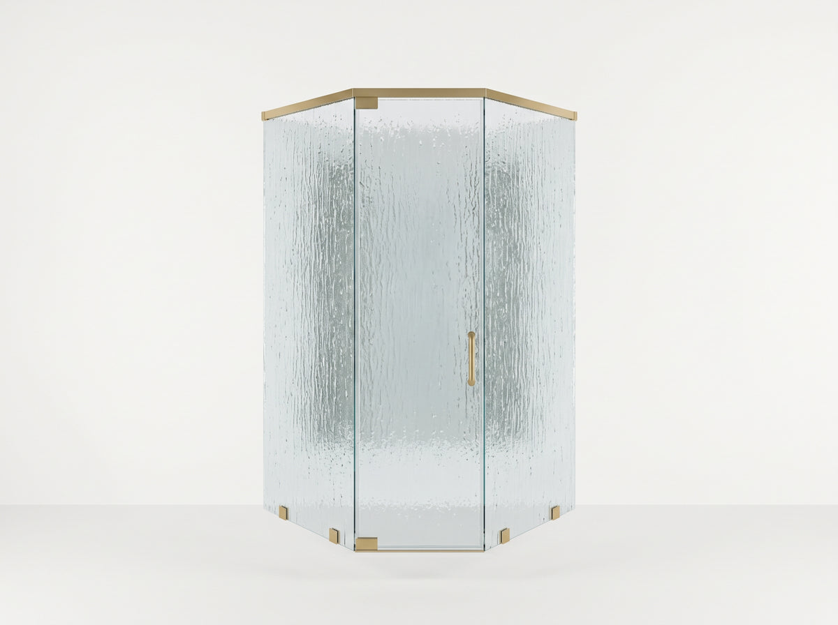 A modern hexagonal corner shower enclosure with textured, frosted glass panels and polished brass hardware, set against a clean white studio background.