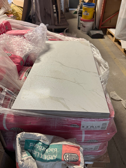 Stack of tiles with packaging materials on a cluttered background