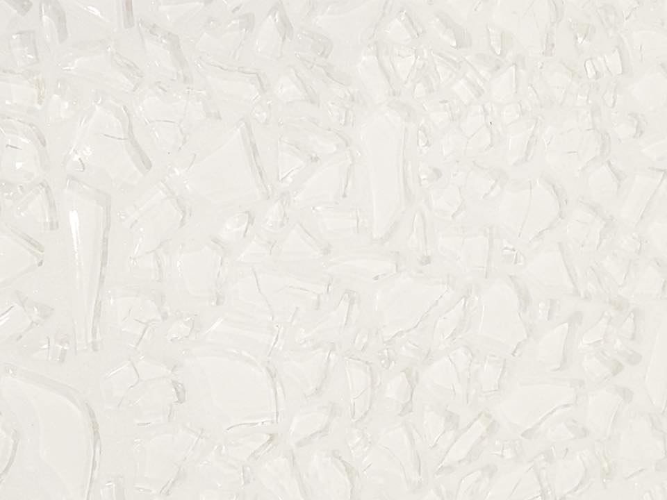 A close-up image of a white grout line, showing its texture and the fact that it is not solid white, but has some variation.