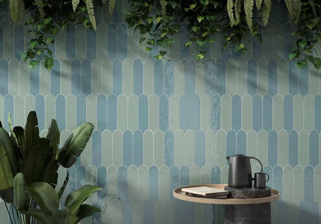 Decorative wall with geometric pattern, plants, and a small table with a teapot.