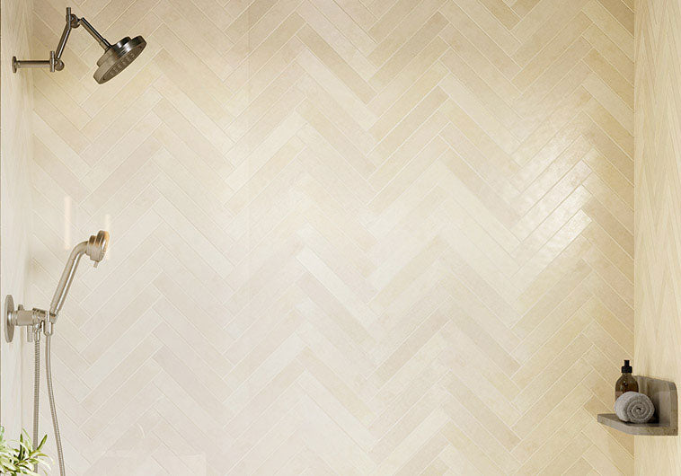 Halva 2x12 Matte ivory ceramic tile in a herringbone shower wall