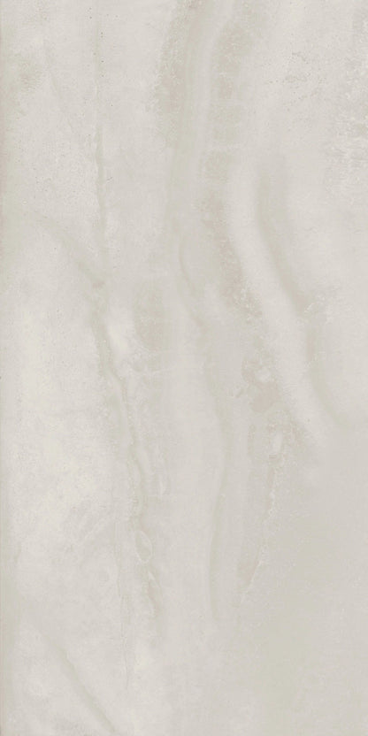 A close-up of a light warm off-white or cream marble-like surface with soft beige veining and a slightly glossy finish.