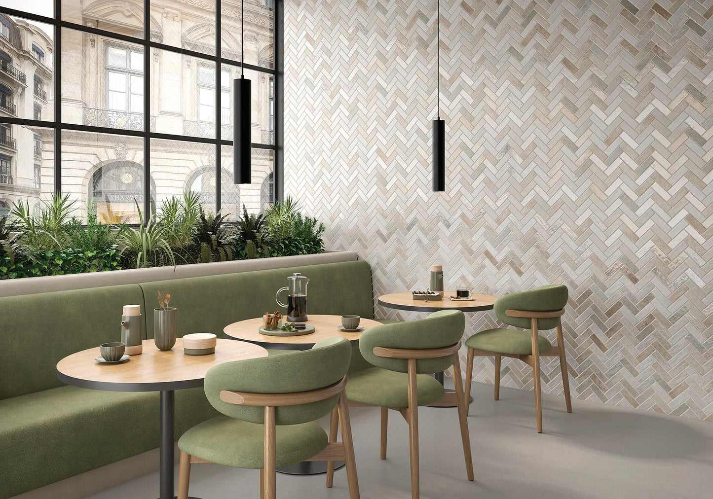Modern restaurant interior with green chairs and tables against a patterned wall.