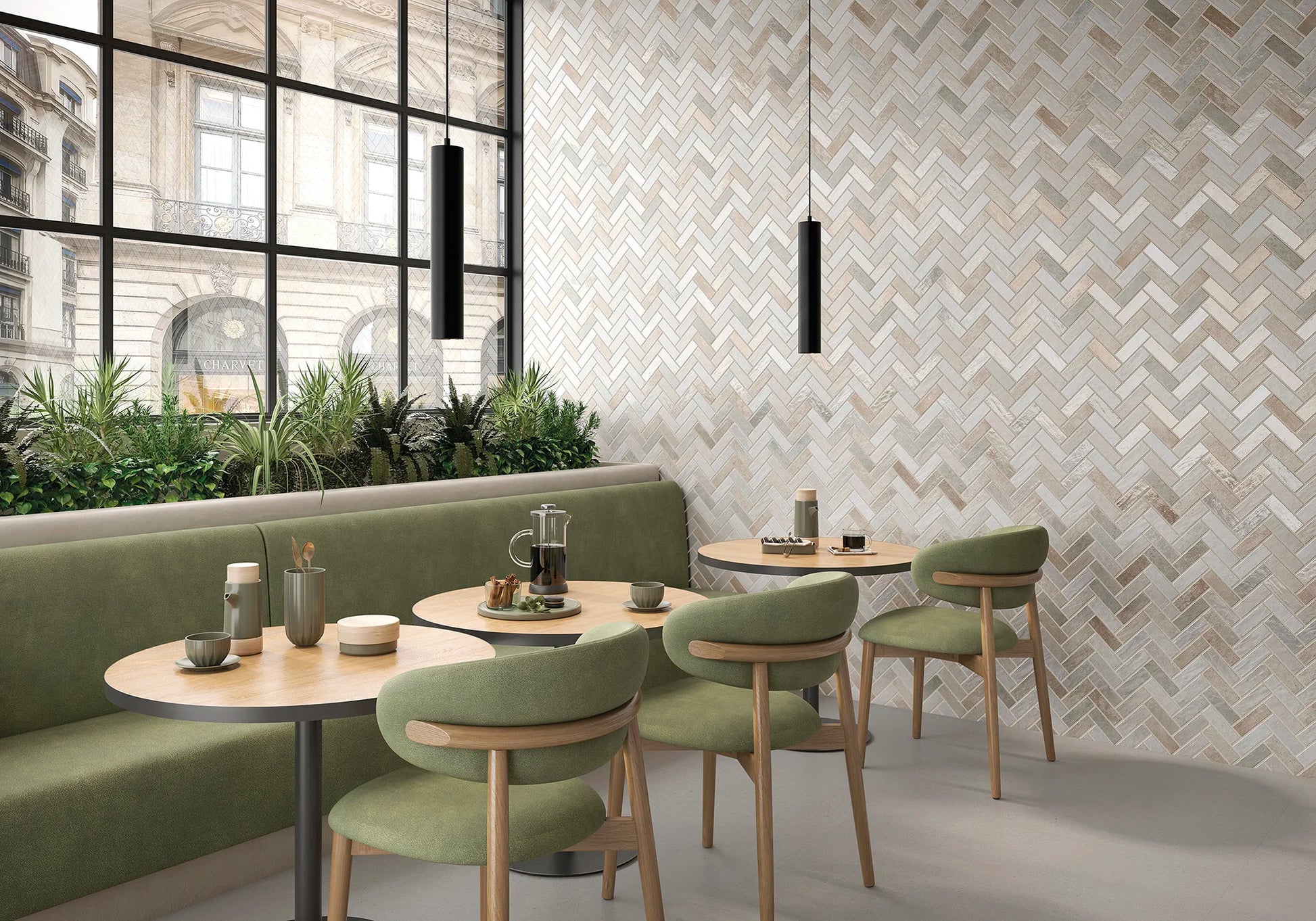 Modern restaurant interior with green chairs and tables against a patterned wall.