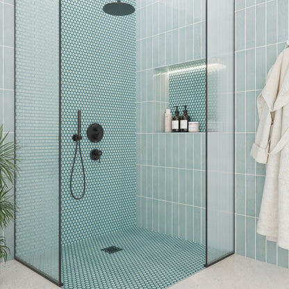 Modern shower with teal mosaic tiles and glass door