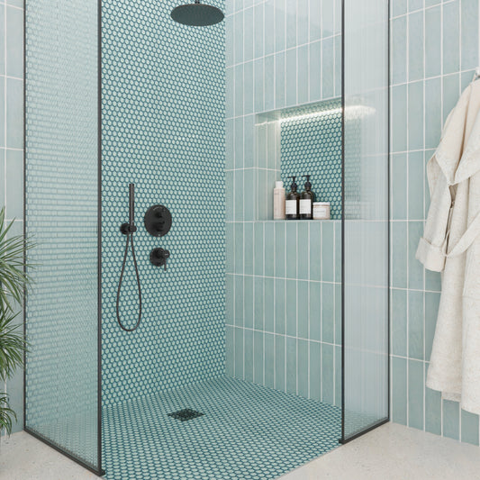 Modern shower with teal mosaic tiles and glass door
