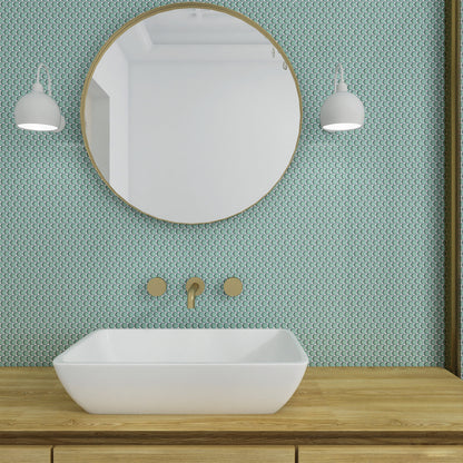 Bathroom with round mirror, white sink, and patterned green wall.