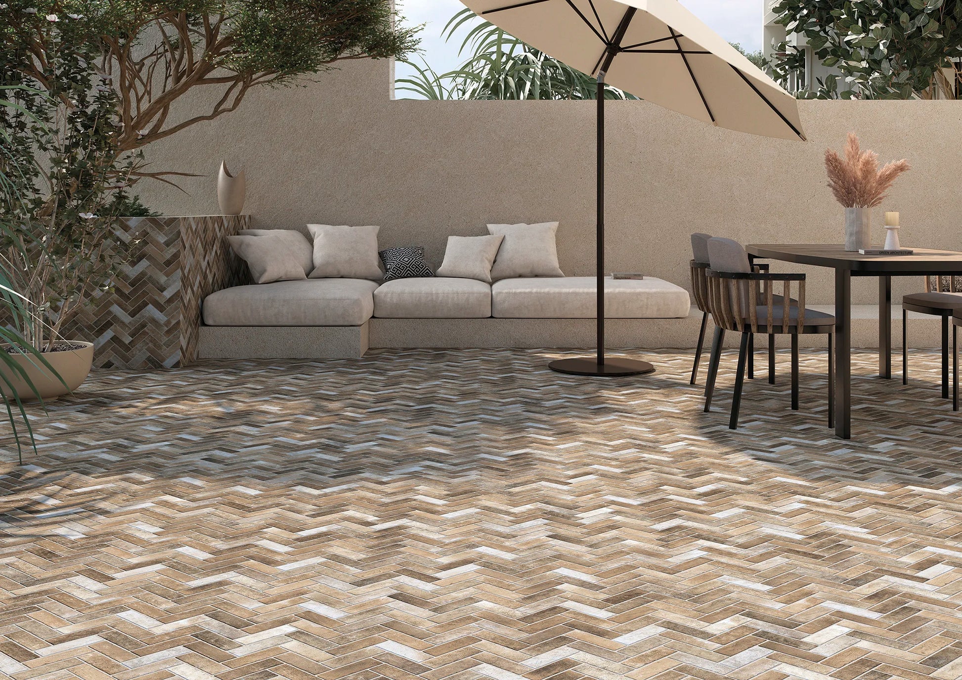Outdoor patio with herringbone patterned tiles, furniture, and umbrella.