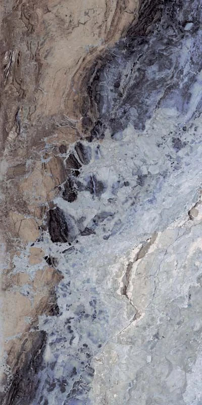 Close-up of a textured stone surface with beige, brown, and gray colors.