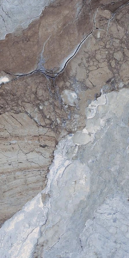 Close-up of a textured surface with cracks and variations in color.