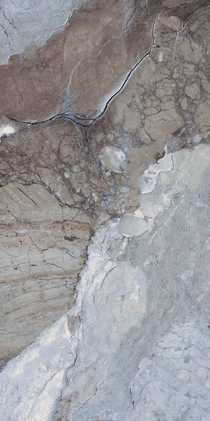 Close-up of a textured surface with cracks and variations in color.