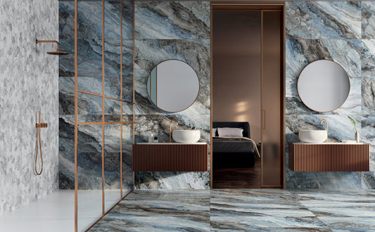 Bathroom with marble walls, a shower, and a vanity area.
