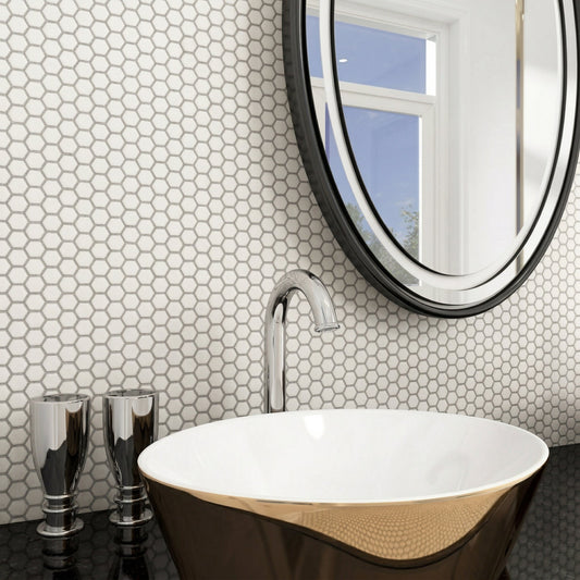 Bathroom with hexagonal tile pattern, round mirror, and freestanding bathtub.