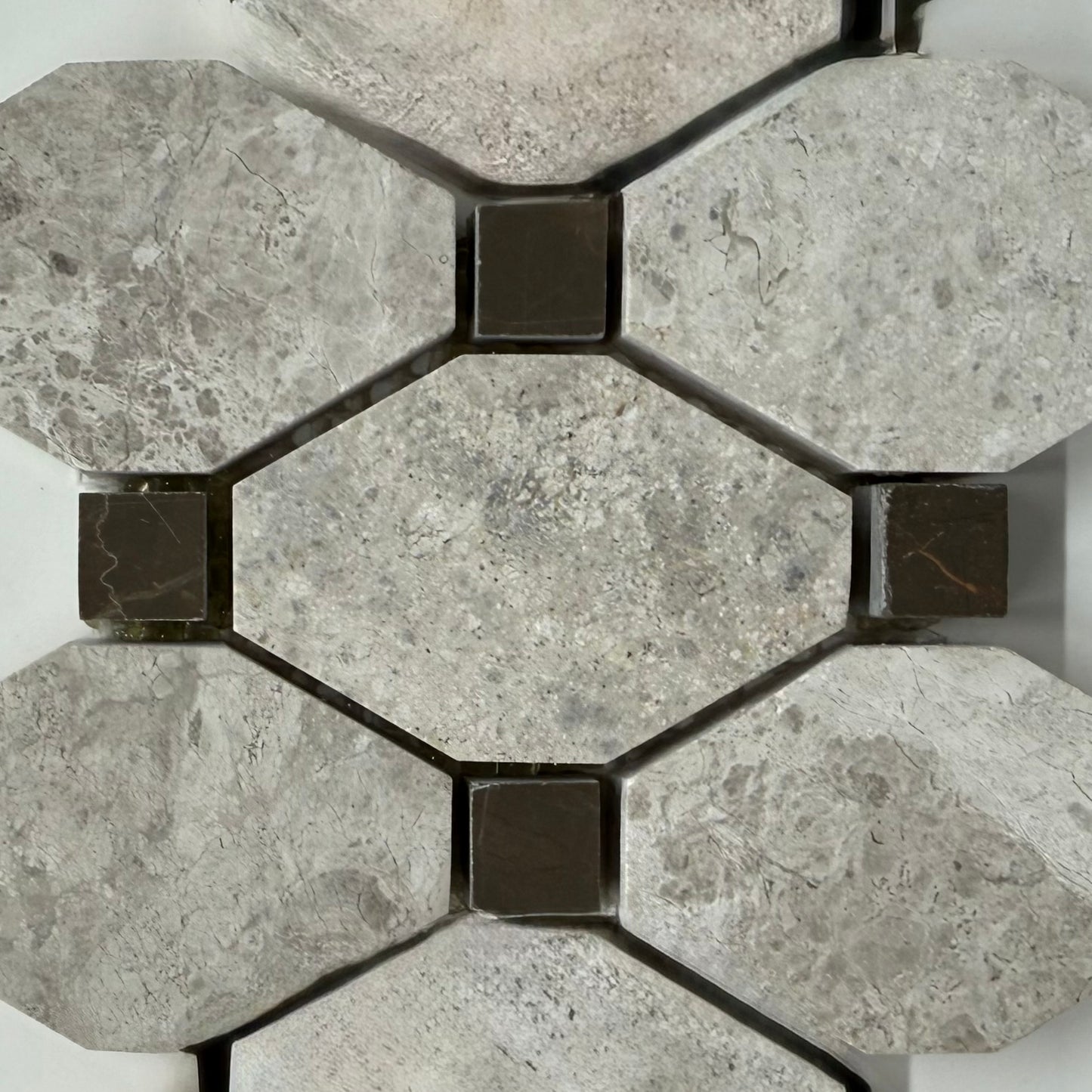 Hexagonal stone tiles with a geometric pattern on a white background