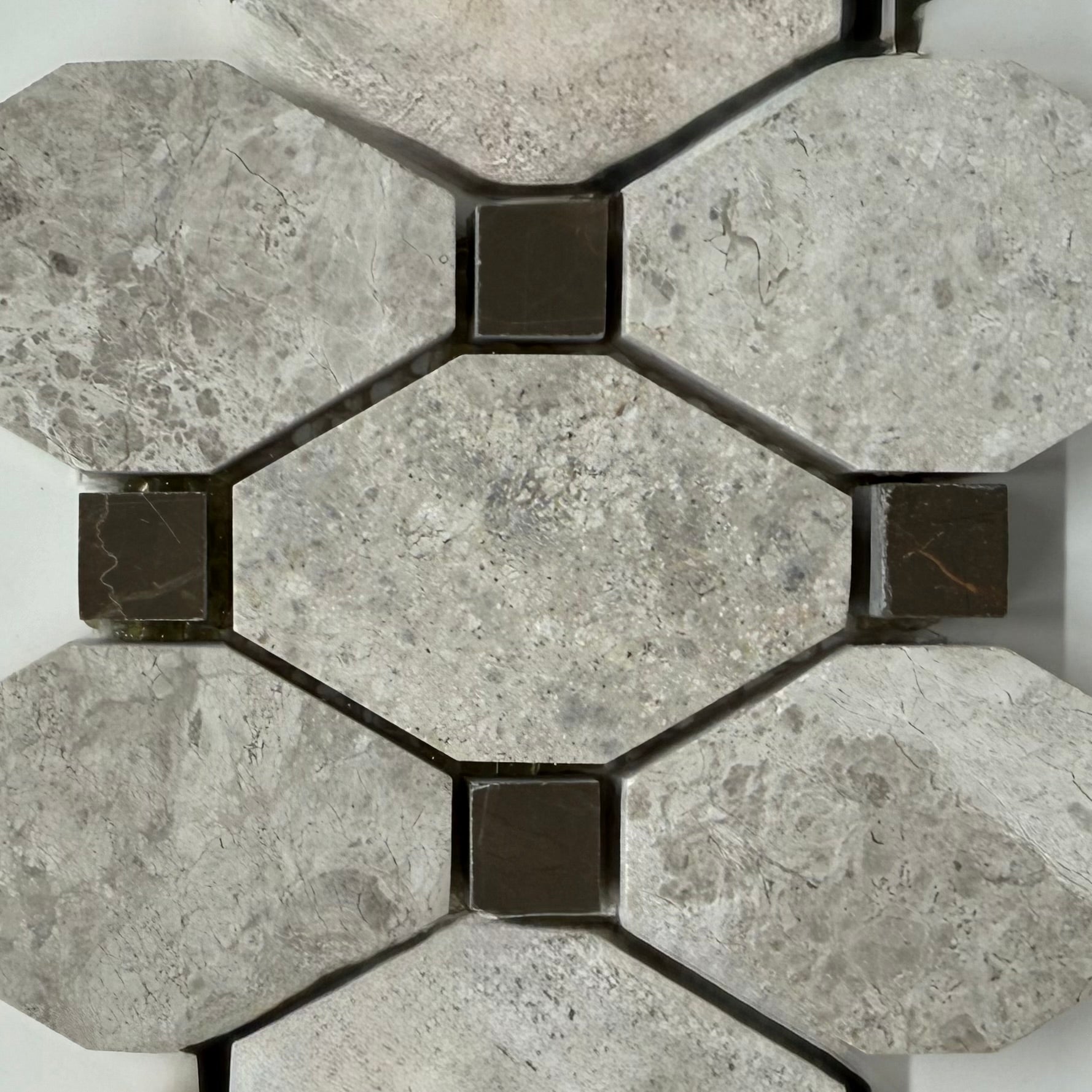Hexagonal stone tiles with a geometric pattern on a white background