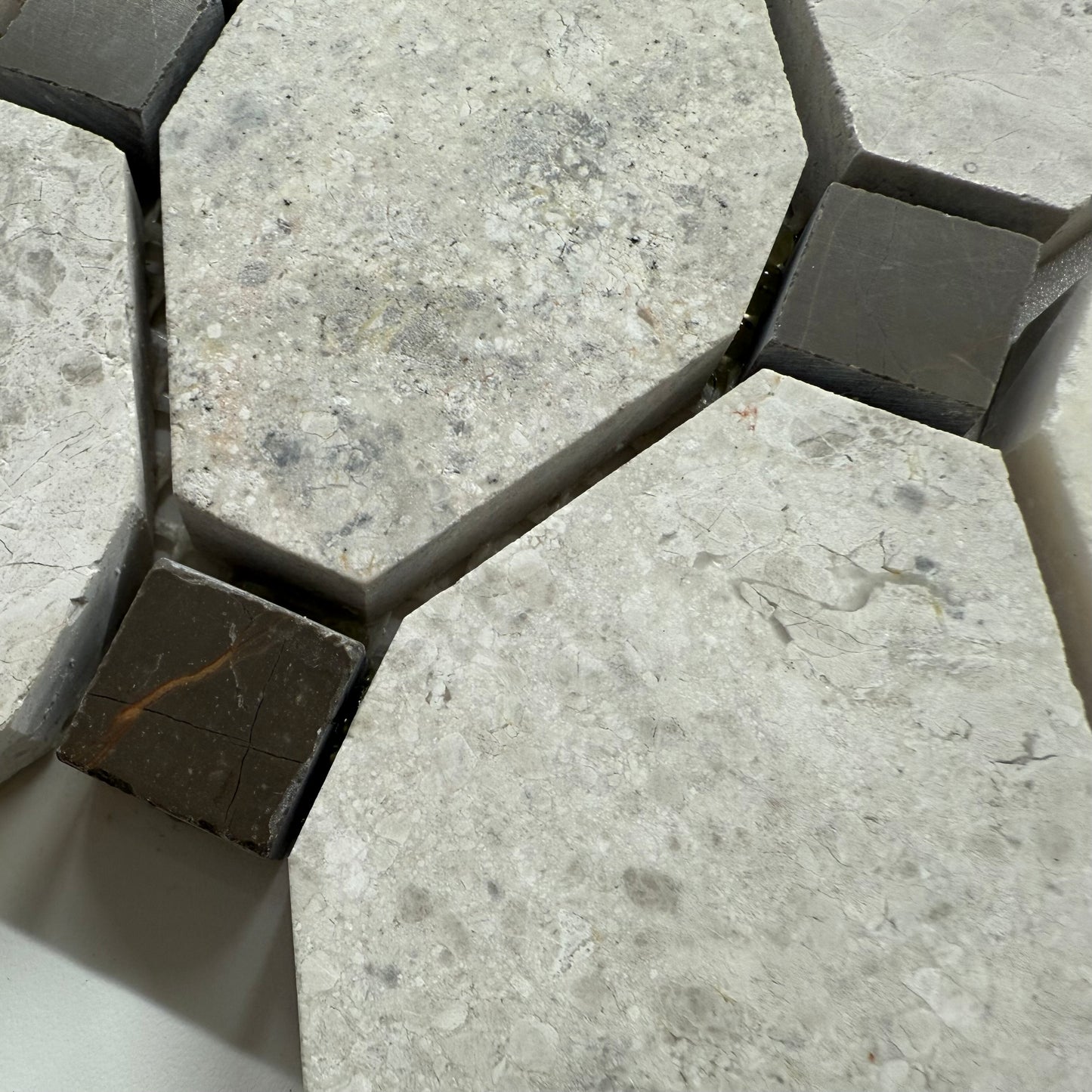 Close-up of hexagonal stone tiles with a focus on texture and color variation.