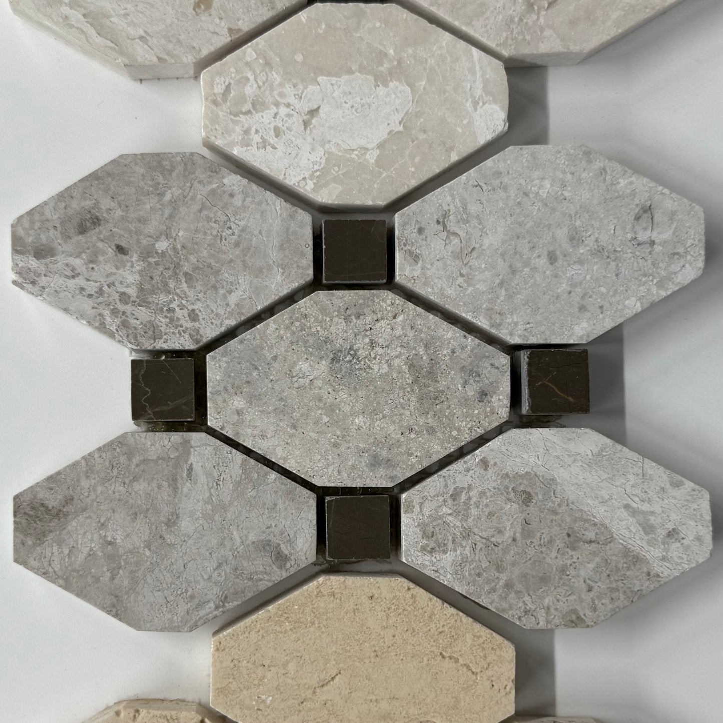 Hexagonal stone tiles with a mix of gray and beige colors on a white background
