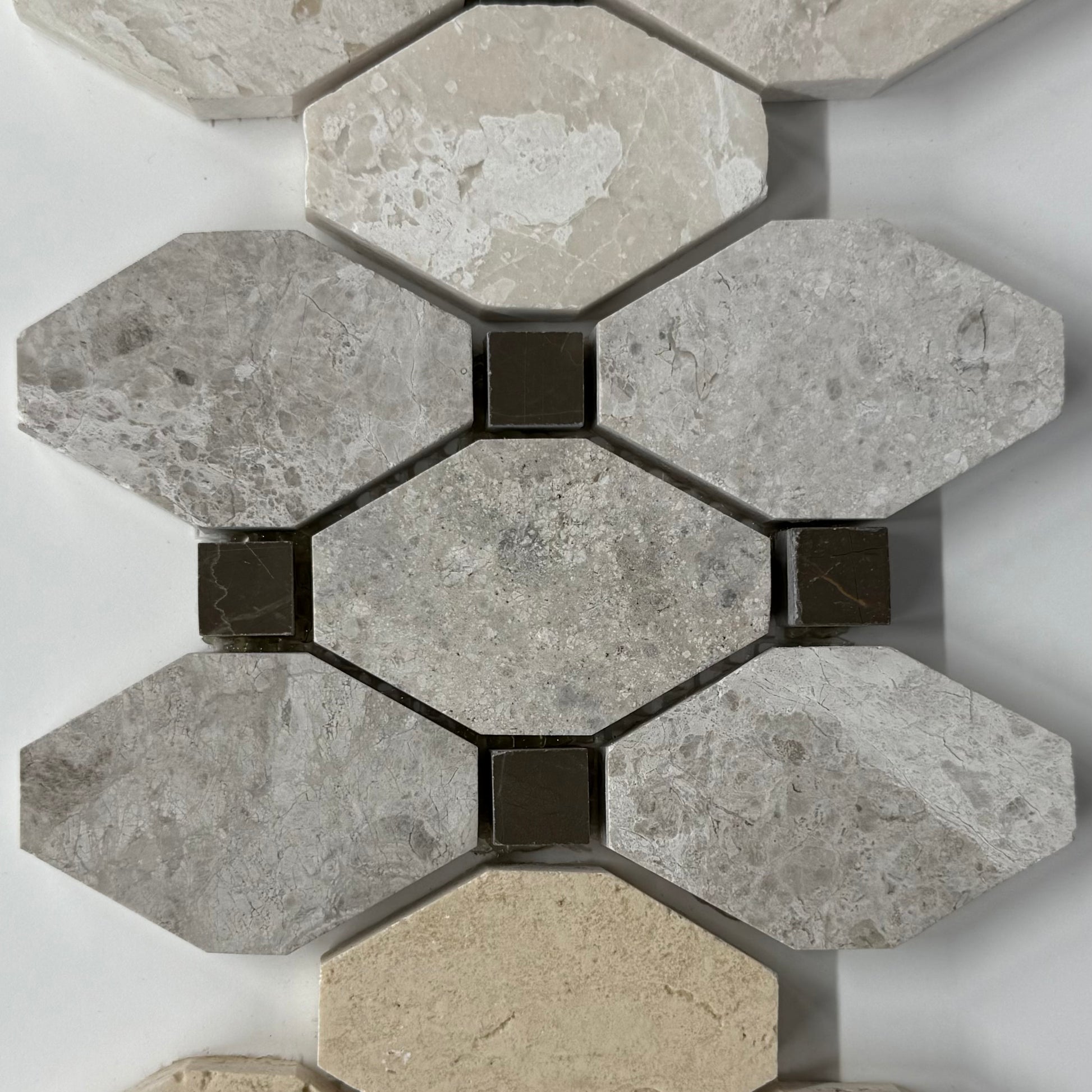 Hexagonal stone tiles with a mix of gray and beige colors on a white background