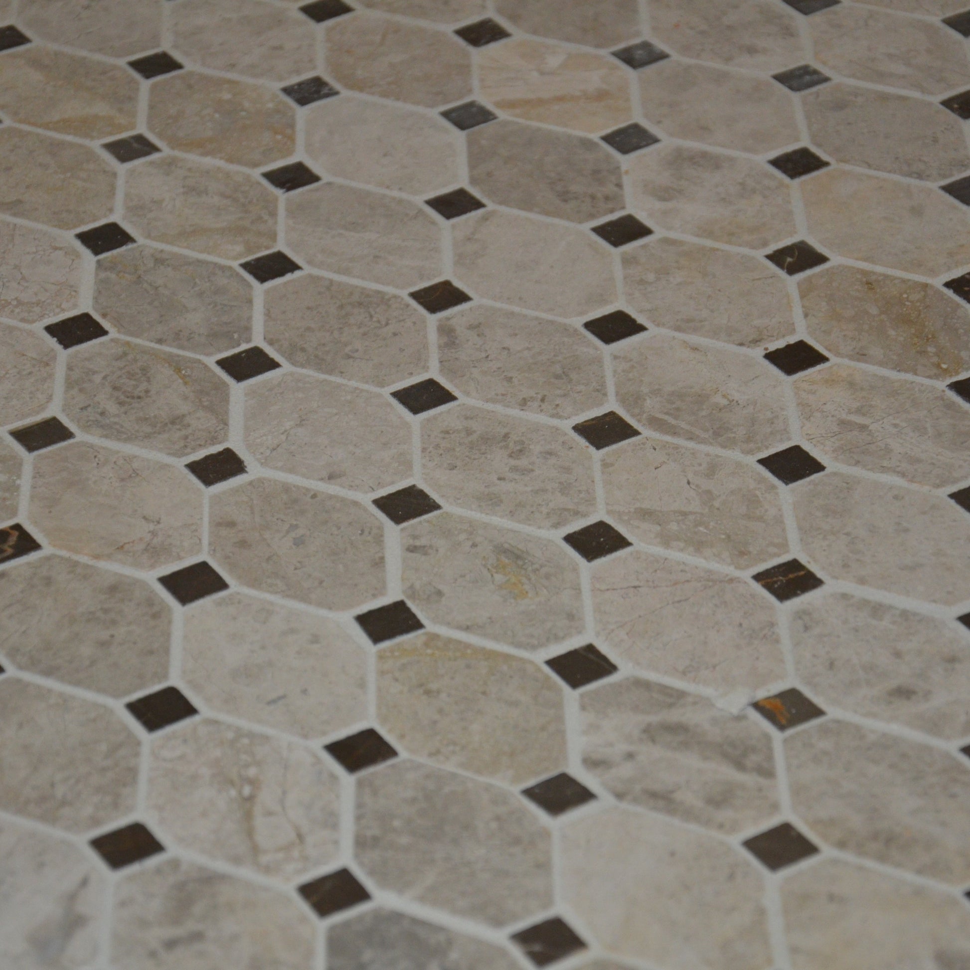 Hexagonal tile pattern with brown accents on a floor