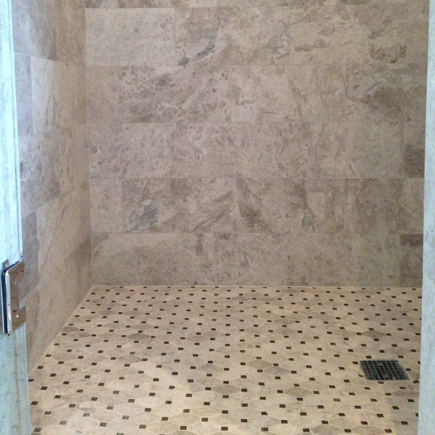 Tile shower with stone-patterned walls and floor